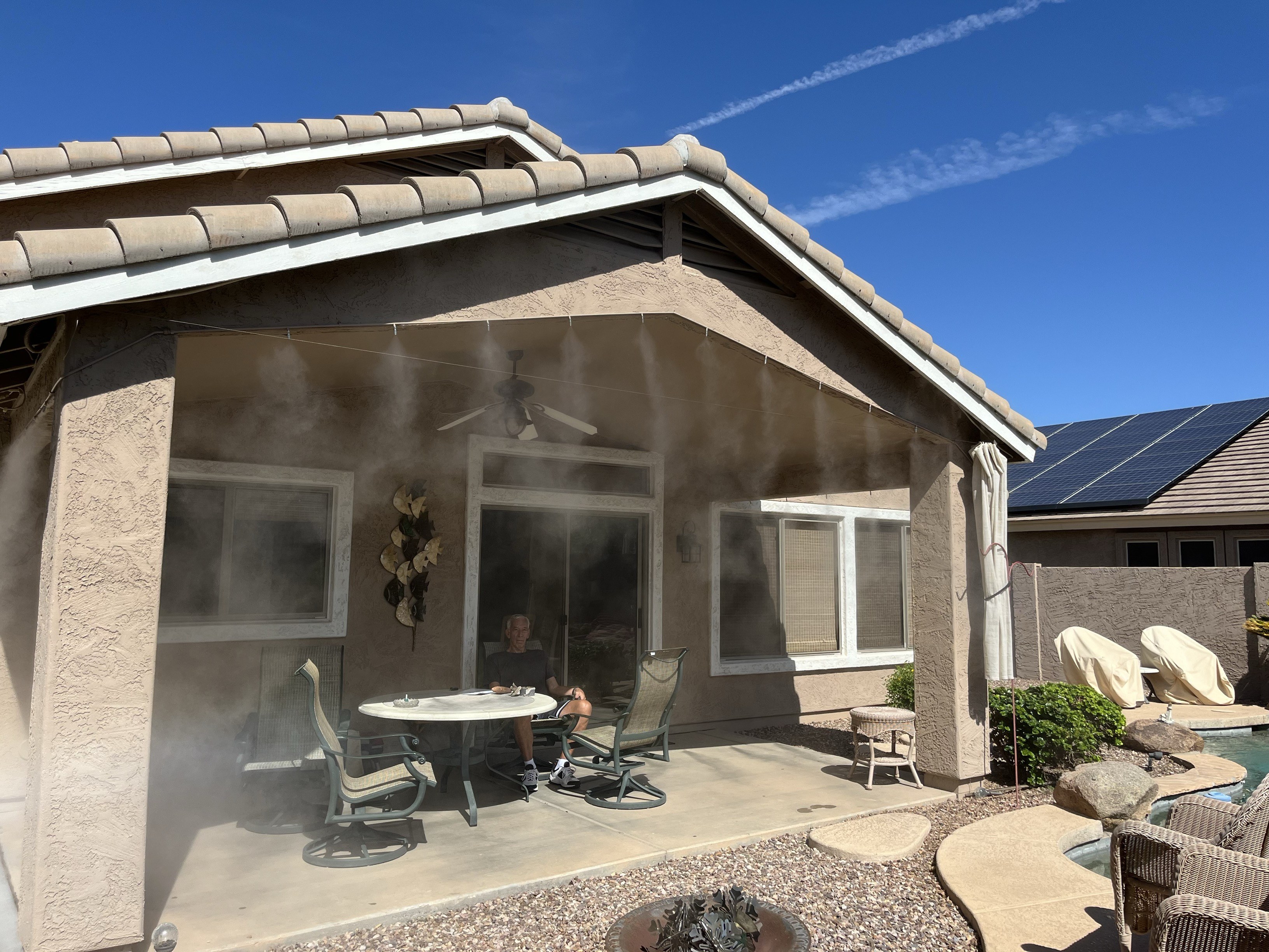Patio misting system cooling an outdoor space in Gilbert