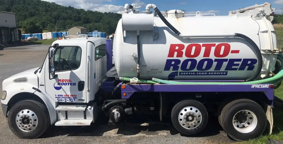 Roto-Rooter Septic Tank Service branded pumping truck in parking lot